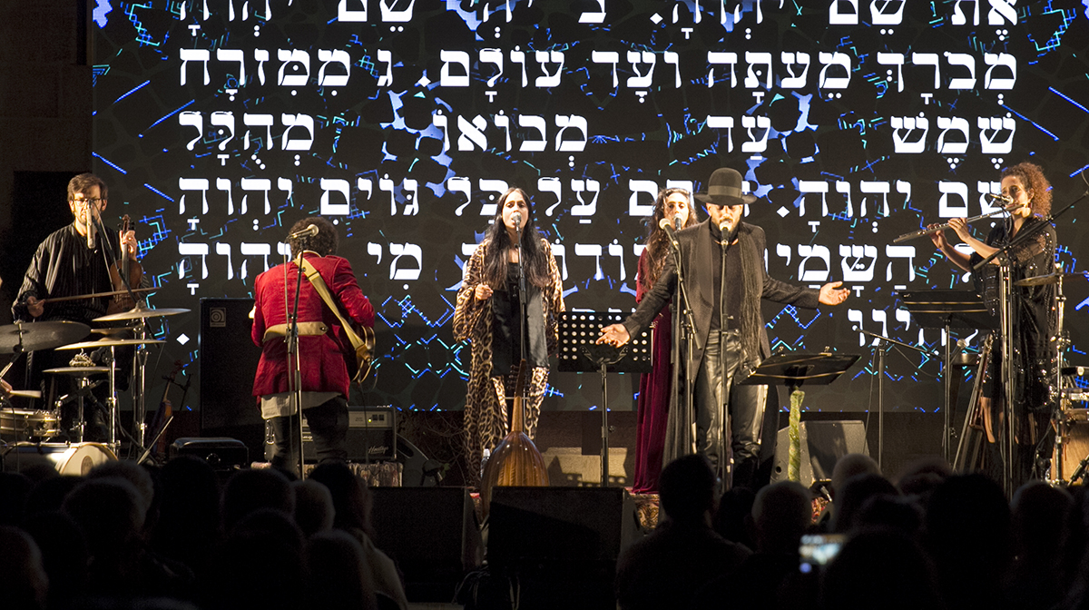The band Yemen Blues performs against a backdrop of Hebrew writing on the stage’s back wall.